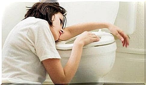 woman looks nauseous at toilet seat