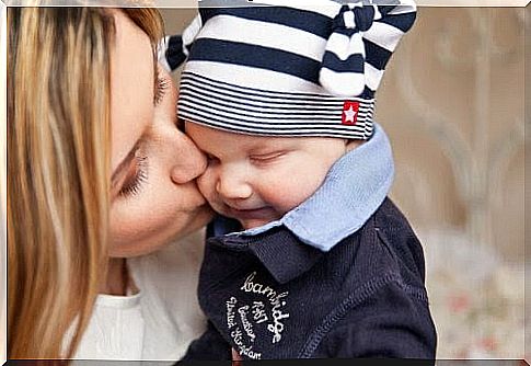 mom kisses baby