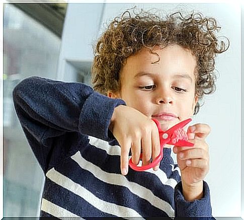 Boy cuts with scissors