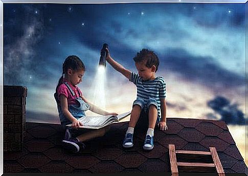 children on roof at dusk with flashlight reading books on science