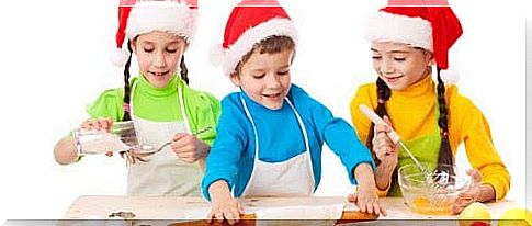 children with Santa hats bake