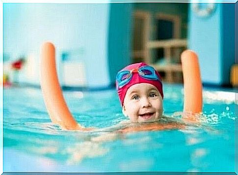 Children in pool with floating toy