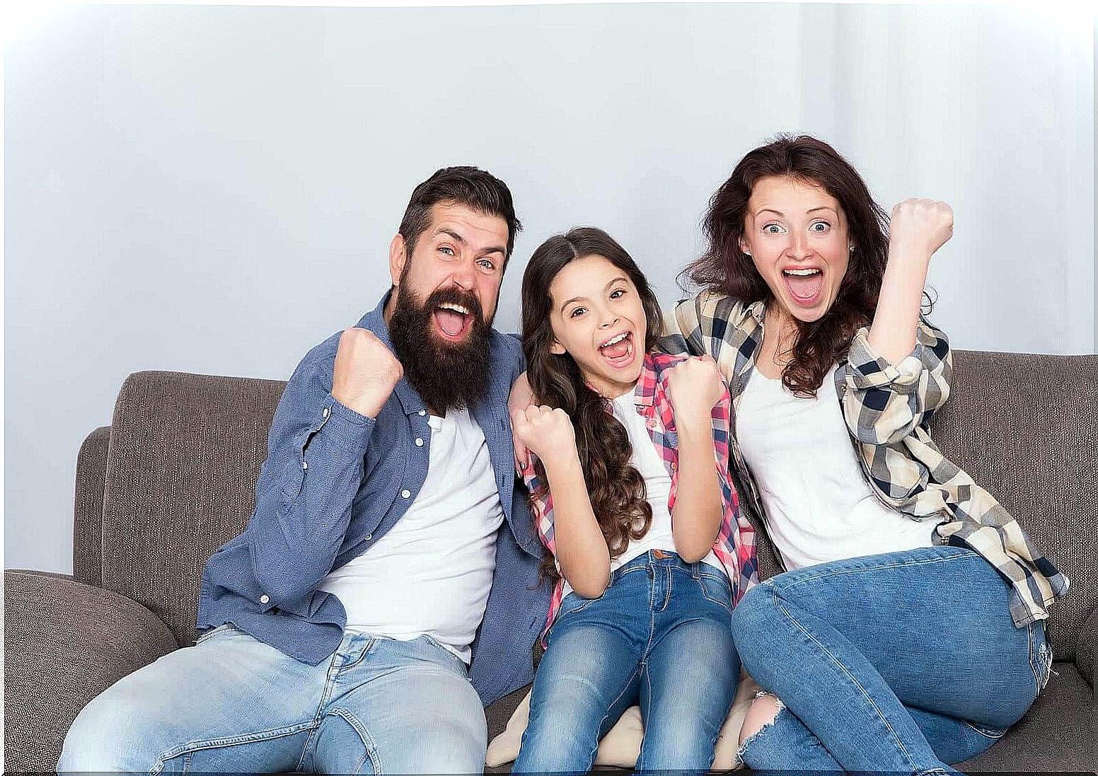 language skills at home: happy family on sofa