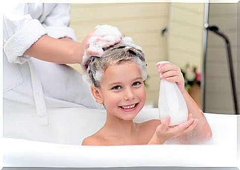 children in bathtub with shampoo in their hair