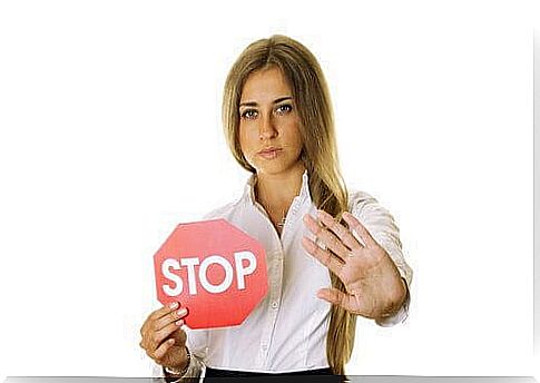 A woman sets boundaries with a stop sign.