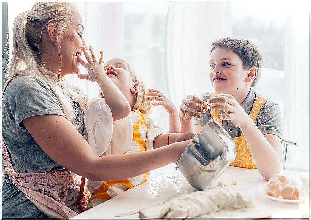 cooking activities for children: mother and child joking in the kitchen