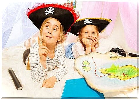 Developmental activities for children: children play with pirate hats