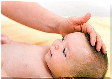 Parent caresses baby