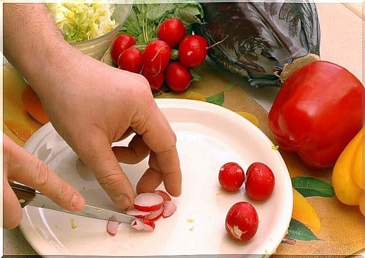 hands cut up radishes