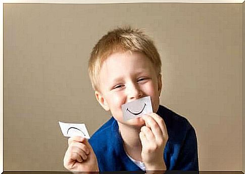 socio-emotional abilities: boy with notes with happy and sad mouth