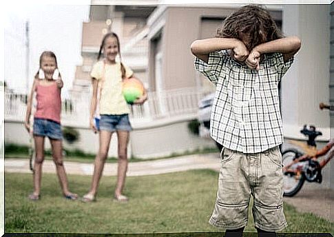 teach children not to tease: children tease sad boy