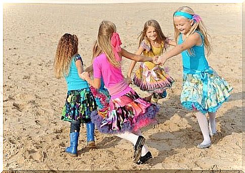 girls dancing on a beach