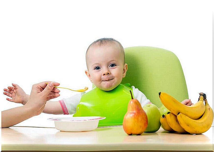 recommended fruits: baby is fed with fruit