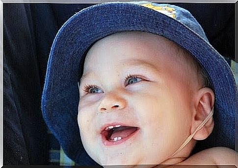 baby smiling with his first tooth