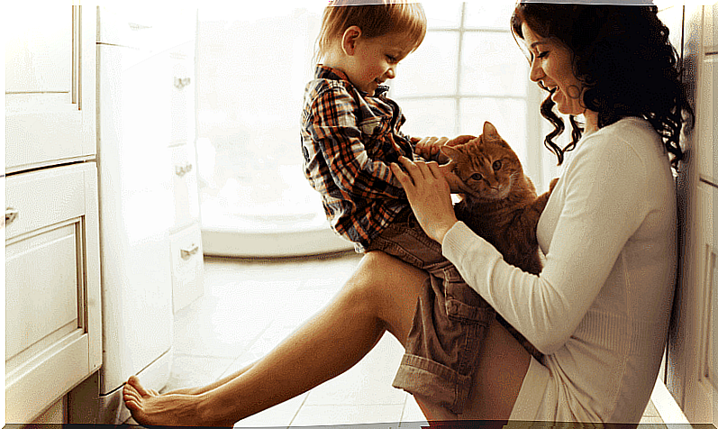 Mom holds son and cat