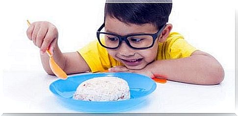 Boy looks skeptically at his food