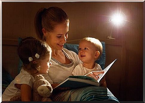 mother reads bedtime story for two small children