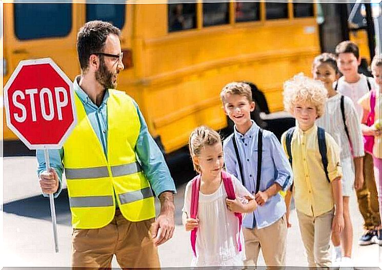 Teaching children road safety: Man with stop sign