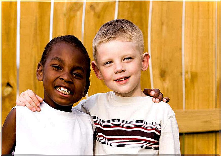 Two boys with their arms around each other's shoulders.