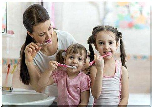 Family brushing teeth together.