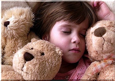 Children sleeping with teddy bear.